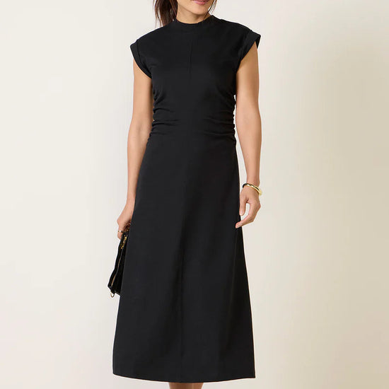 Woman wearing a black dress against a white background