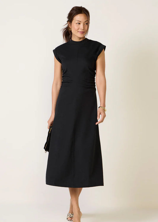 Woman wearing a black dress against a white background