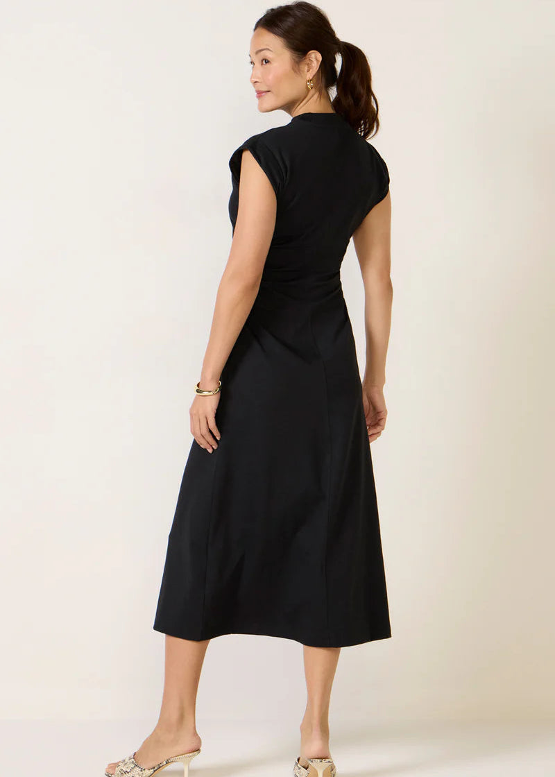 Woman wearing a black dress against a white background