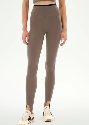 high-waisted taupe-brown stirrup leggings with a black dual waistband,