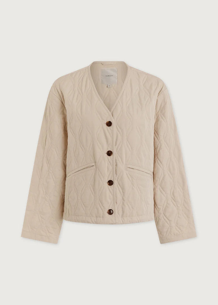 Beige quilted jacket with button details on a white background