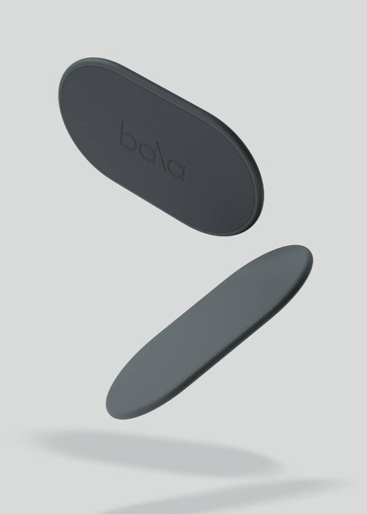 Two black oval objects with 'bala' branding on a light gray background