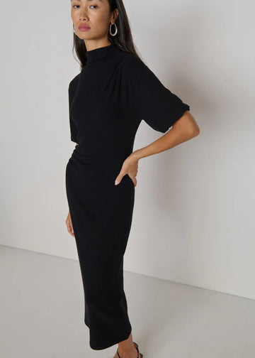 woman wearing long knit black dress short sleeved