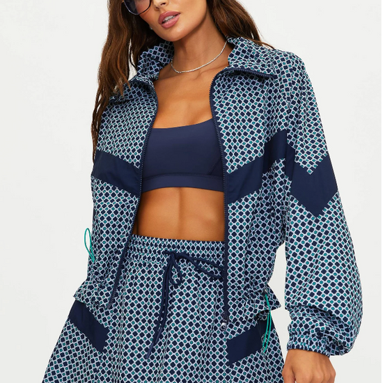 Woman wearing a navy patterned cover-up with a white background