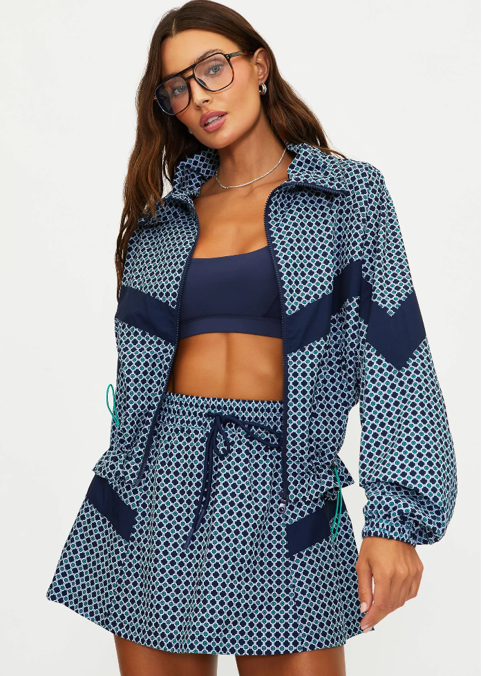Woman wearing a navy patterned cover-up with a white background