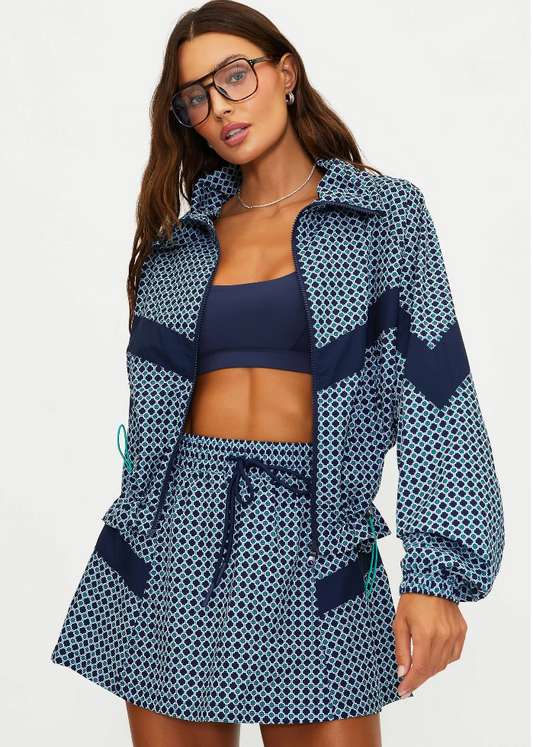 Woman wearing a navy patterned cover-up with a white background