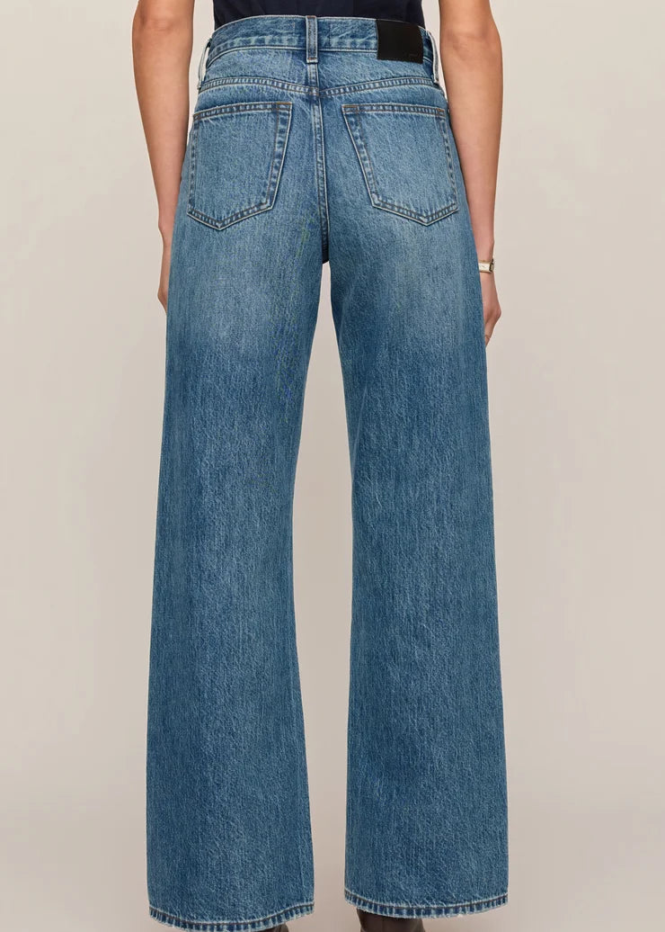 Back view of women’s medium-wash high-rise wide-leg jeans with patch pockets, available at Ekam boutique Newport Beach