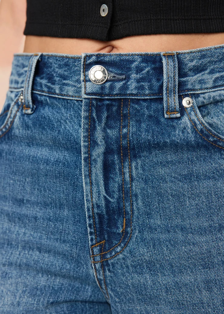 ccloe up view of women’s medium-wash high-rise wide-leg jeans with patch pockets, available at Ekam boutique Newport Beach