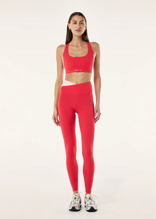 Woman wearing a red athletic outfit on a white background