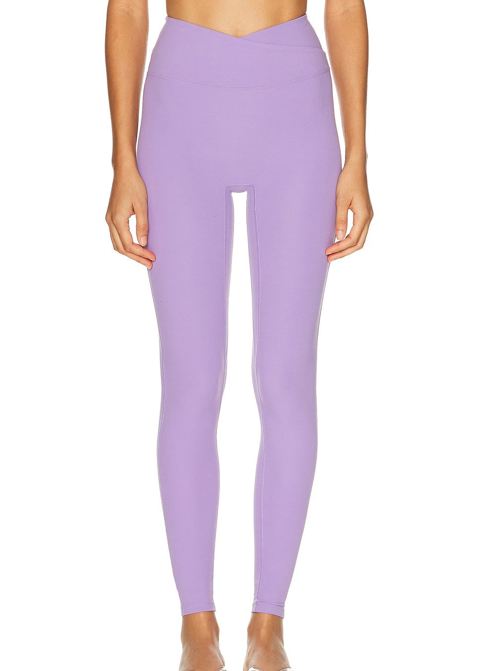 Person wearing lavender leggings on a white background