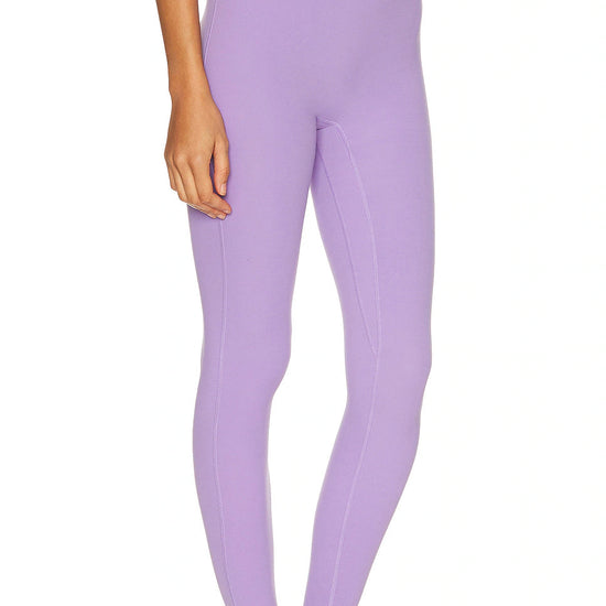 Person wearing lavender leggings on a white background