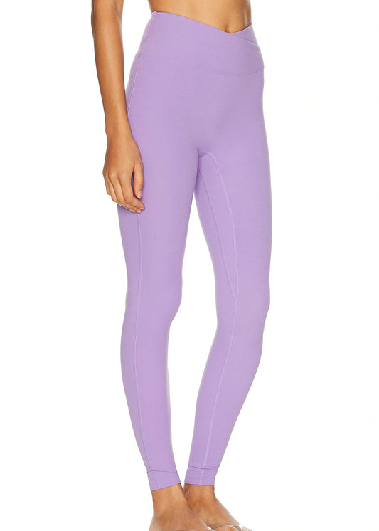 Person wearing lavender leggings on a white background