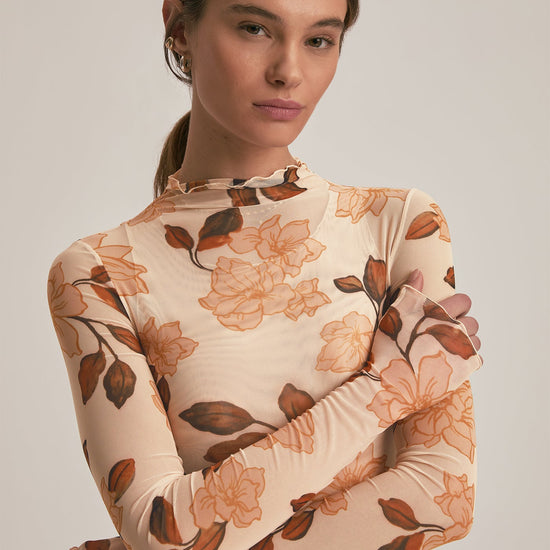 Woman wearing a floral dress with a neutral background