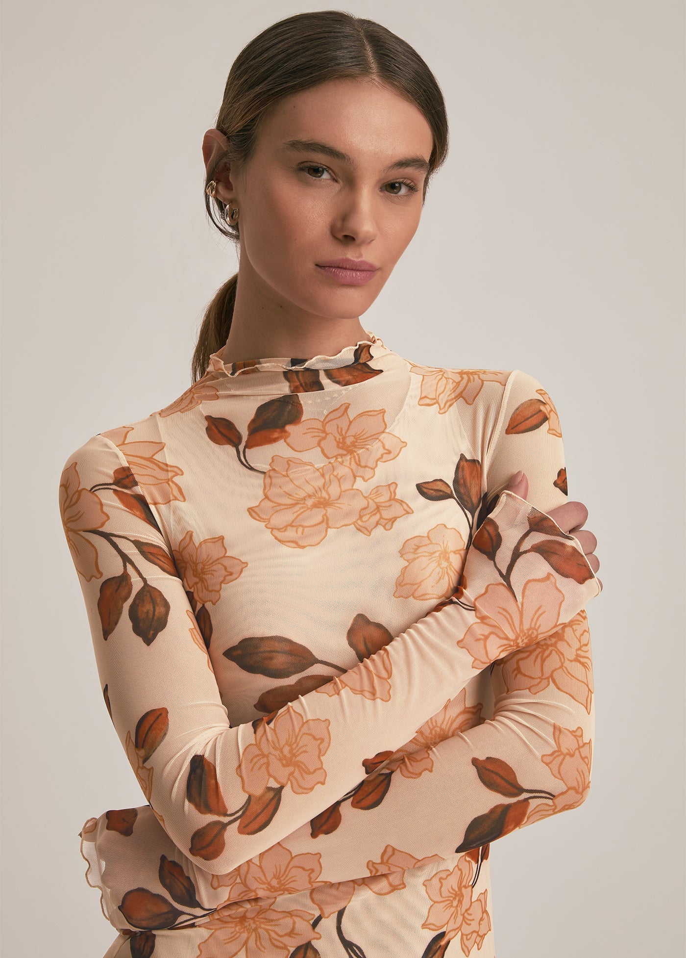 Woman wearing a floral dress with a neutral background