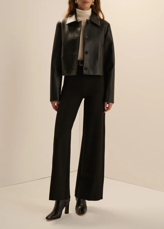 Women’s black leather cropped button-front jacket and midi pencil skirt with front slit, available at Ekam boutique Newport Beach