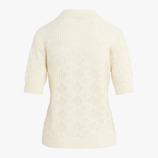 Cream-colored textured top on a white background
