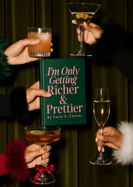 Book titled 'I'm Only Getting Richer & Prettier' held between four hands with drinks, against a dark background.